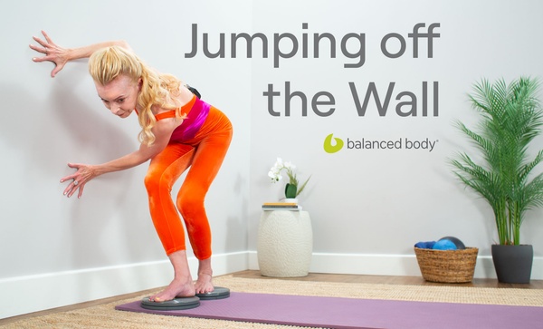 Jumping off the Wall Woman exercising on mat and precision rotator discs