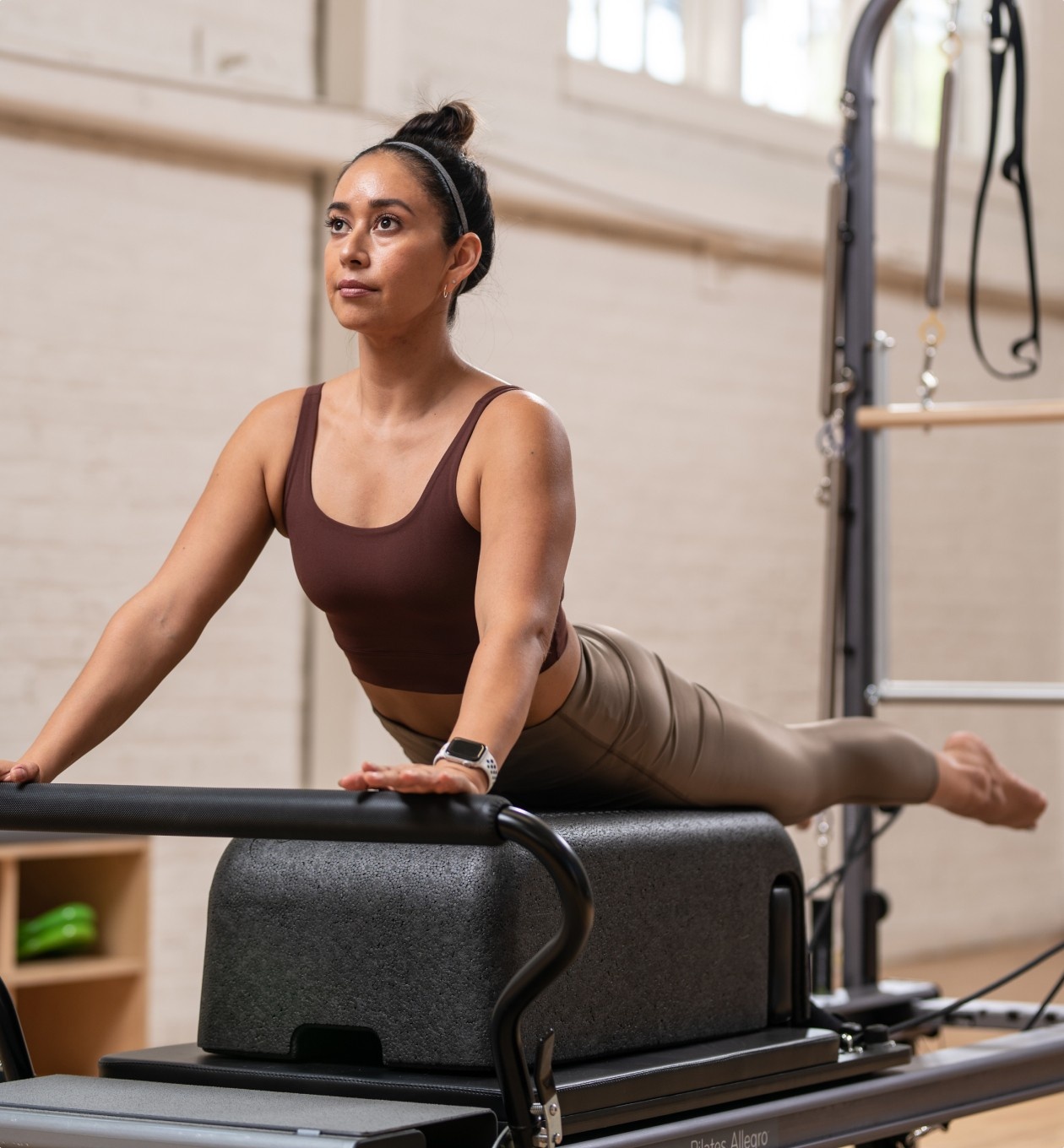 pilates sitting box reformer accessory on tower reformer