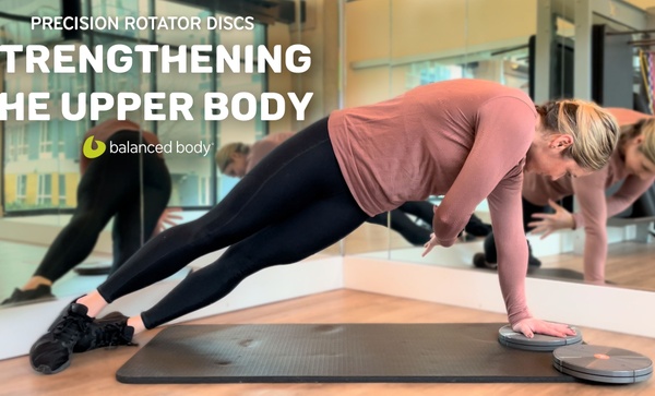 Strengthening the Upper Body Woman instructing exercising on mat using Precision Rotator Discs