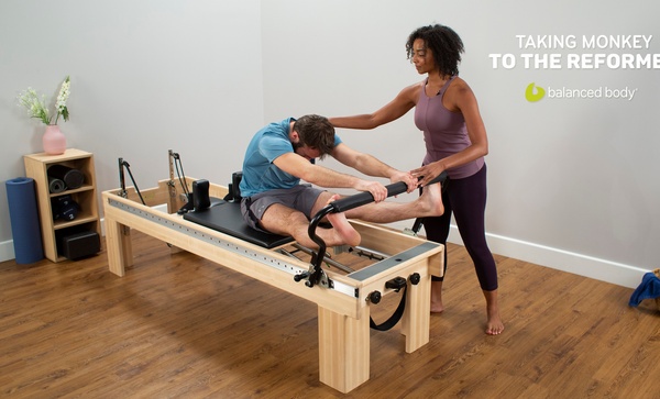 taking monkey to the reformer woman instructor with student on clinical